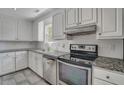 Modern kitchen with white cabinets and granite counters at 8300 Berringer Bluff Dr, Charleston, SC 29418