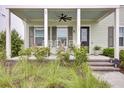 Charming front porch with rocking chairs and lush landscaping at 106 Sandy Bend Ln, Summerville, SC 29486