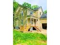 Under construction home with light beige siding and a wrap-around porch at 4504 Smoak Rd, Meggett, SC 29449