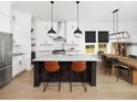 Modern kitchen features island, stainless steel appliances, and white cabinetry at 411 Swaying Pine Lane, Summerville, SC 29486