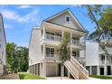Two-story home with elevated ground floor, balcony, and stairs at 1304 Lieben Rd, Mount Pleasant, SC 29466