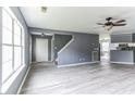 Spacious living room with gray walls, wood-look floors, and a ceiling fan at 215 Cantilever Ct, Summerville, SC 29486