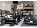 Modern garage interior with a car lift, mezzanine level, and ample storage at 565 Faison Rd # 56, Mount Pleasant, SC 29466