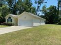 House exterior showcasing a large yard and white garage at 422 Constance St, Walterboro, SC 29488
