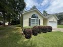 Side view of a yellow house with nicely landscaped yard at 422 Constance St, Walterboro, SC 29488
