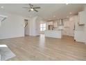 Open living room and kitchen with hardwood floors and modern appliances at 2193 Blue Bayou Blvd, Johns Island, SC 29455