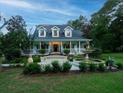 Beautiful two-story home with wrap-around porch and fountain at 6949 Maybank Hwy, Wadmalaw Island, SC 29487