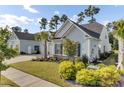 Charming light blue home with two-car garage and lush landscaping in a quiet neighborhood at 377 Tupelo Lake Dr, Summerville, SC 29486