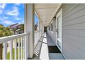 Bright condo hallway with white railings at 100 Mariners Cay Dr, Folly Beach, SC 29439