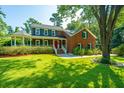 Brick house with large front yard, porch and mature trees at 181 Pekoe Ct, Summerville, SC 29483