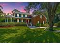 Brick house with large front yard, porch and mature trees at 181 Pekoe Ct, Summerville, SC 29483