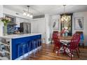 Modern kitchen with blue island, stainless steel appliances, and hardwood floors at 1637 Live Oak Park, Seabrook Island, SC 29455