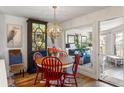 Bright dining area with red chairs, round table, and access to a sunroom at 1637 Live Oak Park, Seabrook Island, SC 29455