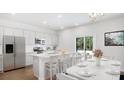 Island kitchen with white cabinets, granite countertops and stainless steel appliances at 1020 Lovebug Ln, Summerville, SC 29485