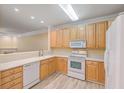 Light wood kitchen cabinets and white appliances at 1025 Riverland Woods Pl # 610, Charleston, SC 29412