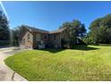 Brick house with a large backyard and driveway at 1229 Central Ave, Summerville, SC 29483