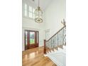 Elegant entryway with hardwood floors, grand staircase, and stained glass door at 775 Navigators Run, Mount Pleasant, SC 29464