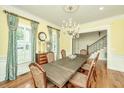 Formal dining room with hardwood floors, chandelier, and elegant window treatments at 775 Navigators Run, Mount Pleasant, SC 29464