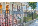 Charming home with mosaic tiled steps and ornate iron gate at 380 Ashley Ave, Charleston, SC 29403
