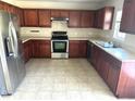 Galley kitchen with wood cabinets and stainless steel appliances at 506 Holiday Dr, Summerville, SC 29483