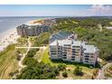 Aerial view of luxurious oceanfront condo building, highlighting its location at 4405 Ocean Clb, Isle of Palms, SC 29451