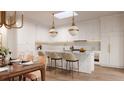 Modern white kitchen with island, breakfast bar, and high-end appliances at 284 Meeting St # 202, Charleston, SC 29401