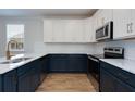 Modern kitchen with white and dark blue cabinets and marble countertops at 427 Grove End Rd, Moncks Corner, SC 29461