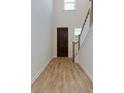 Hardwood floor entryway with stairs and a dark brown front door at 427 Grove End Rd, Moncks Corner, SC 29461