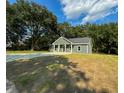 Newly built gray house nestled among trees at 102 Whitesville Rd, Moncks Corner, SC 29461