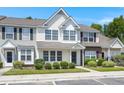 Two-story townhome with neutral siding, landscaping, and a brick accent at 107 Darcy Avenue, Goose Creek, SC 29445