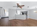 Open living room and kitchen with hardwood floors and ceiling fan at 1120 Monaco Dr, Mount Pleasant, SC 29464