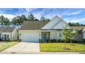 Beige two-story house with gray roof, attached garage, and blue door at 386 Tupelo Lake Dr, Summerville, SC 29486