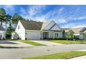 Beige two-story house with gray roof and attached garage at 386 Tupelo Lake Dr, Summerville, SC 29486