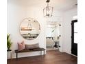 Bright entryway with hardwood floors, a bench, and a large round mirror at 366 Wappoo Trace Ln, Summerville, SC 29486