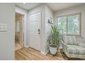 Bright entryway with white door, wood floors, and a comfy chair at 266 Alexandra Dr # 15, Mount Pleasant, SC 29464