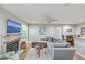 Living room with sectional sofa, fireplace, and large TV at 266 Alexandra Dr # 15, Mount Pleasant, SC 29464