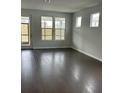 Spacious living area with hardwood floors and large windows at 741 Blue Iris Way, Summerville, SC 29486