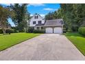Two-story home with double garage and manicured lawn at 5 Avon Ct, Charleston, SC 29407