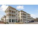 Exterior view of a multi-story building with balconies and retail spaces at 301 Longshore St # 441, Charleston, SC 29492