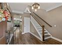Bright entryway with hardwood floors and wooden staircase at 316 Bay Village Ln, Moncks Corner, SC 29461