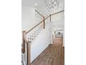 Elegant staircase with oak railings and hardwood flooring at 425 Grove End Rd, Moncks Corner, SC 29461