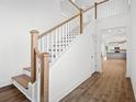 Elegant staircase with oak railings and hardwood flooring at 425 Grove End Rd, Moncks Corner, SC 29461