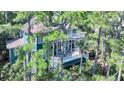 Back exterior view of home with large deck at 11 Falcon Point Rd, Kiawah Island, SC 29455