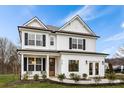 Two story white farmhouse style home with black shutters and a welcoming front porch at 416 Grove End Rd, Moncks Corner, SC 29461