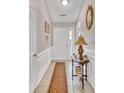 Bright entryway with tiled floors, wainscoting, and a console table at 2851 Curran Pl, Mount Pleasant, SC 29466