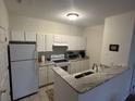 Efficient kitchen with granite counters and white cabinets at 1600 Long Grove Dr # 628, Mount Pleasant, SC 29464