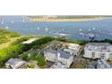 Aerial view of waterfront community with upscale homes, marina, and bridge at 301 Longshore St # 423, Charleston, SC 29492