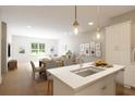Modern kitchen island with white cabinetry and quartz countertop at 7421 Indigo Palms Way, Johns Island, SC 29455