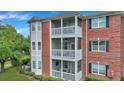 Three-story brick building with screened-in balconies and landscaping at 1443 Cambridge Lakes Dr, Mount Pleasant, SC 29464