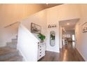 Bright and airy entryway with staircase, mirror, and decorative accents at 217 Pink Azalea St, Summerville, SC 29485